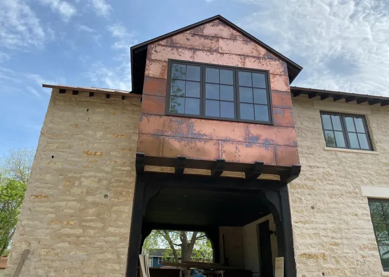 Copper metal panel facade on a stone building for Metal Roof Coating in Brewster
